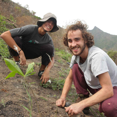 One Tree Planted: Two people smiling at the camera as they plant