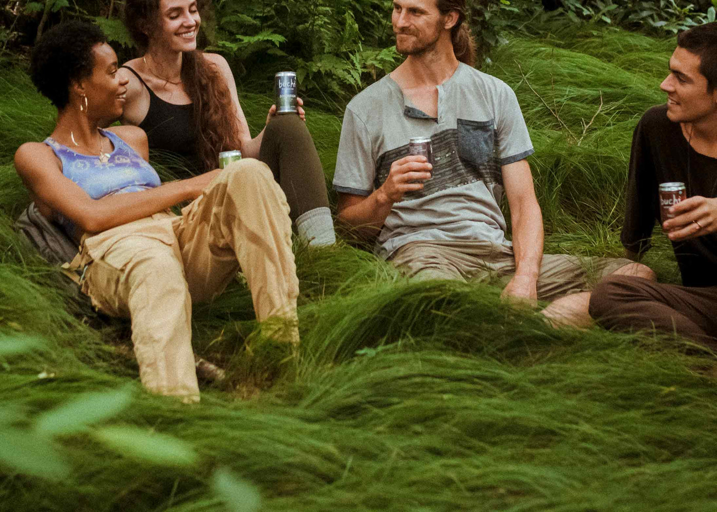 4 friends on a hike, lounging in the grass, drinking Buchi. It seems fun, I'm lowkey jealous.